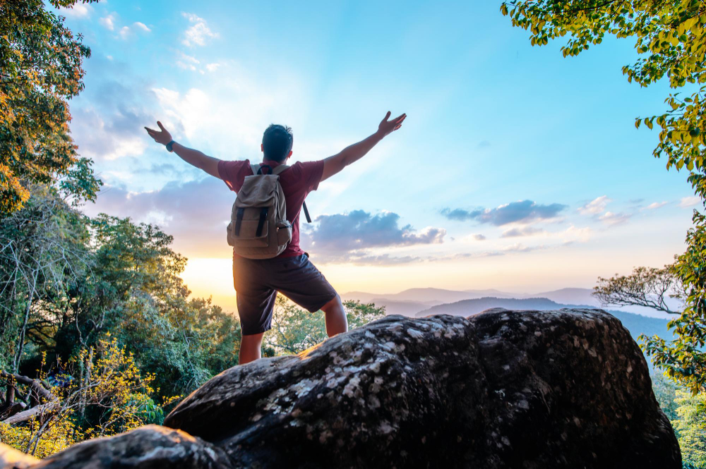 rear-view-back-young-asian-hiking-man-standing-riseup-hands-with-happy-peak-rocky-mountain-copy-space-outdoor-workout-fitness-fitnesshub-fitnesshub24x7