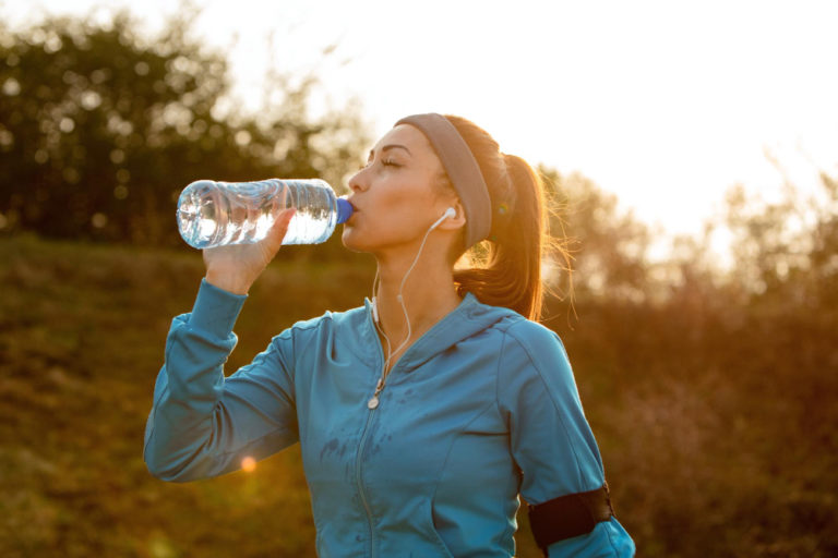 young-athletic-woman-drinking-water-with-her-eyes-closed-while-having-water-break-during-morning-run-nature-fitness-fitnesshub24x7-fitnesshub